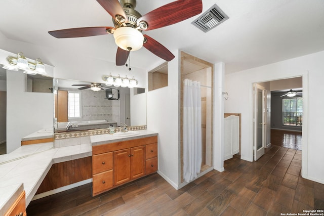 bathroom with hardwood / wood-style floors, vanity, and a bathing tub