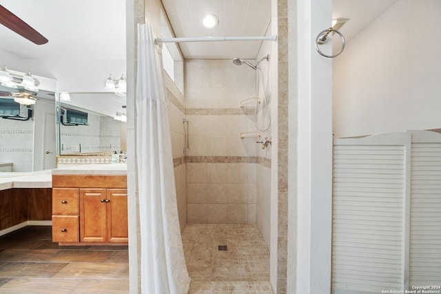 bathroom featuring vanity, walk in shower, and ceiling fan