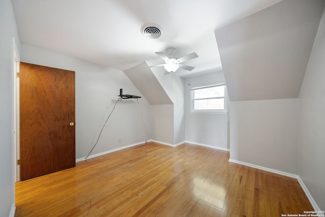 additional living space featuring hardwood / wood-style flooring, ceiling fan, and lofted ceiling