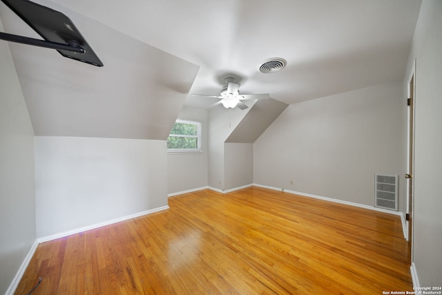 bonus room with lofted ceiling, ceiling fan, and wood-type flooring