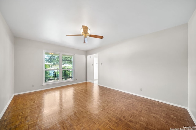 unfurnished room with ceiling fan and parquet flooring