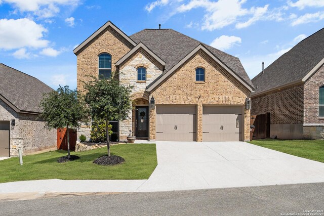 view of front of home featuring a garage and a front lawn