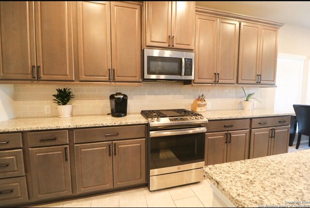 laundry room with light tile patterned flooring and washer and dryer