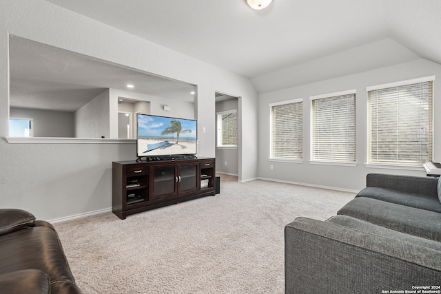 living room featuring light colored carpet, lofted ceiling, and a wealth of natural light