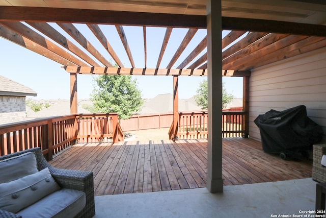 wooden terrace with a pergola and area for grilling