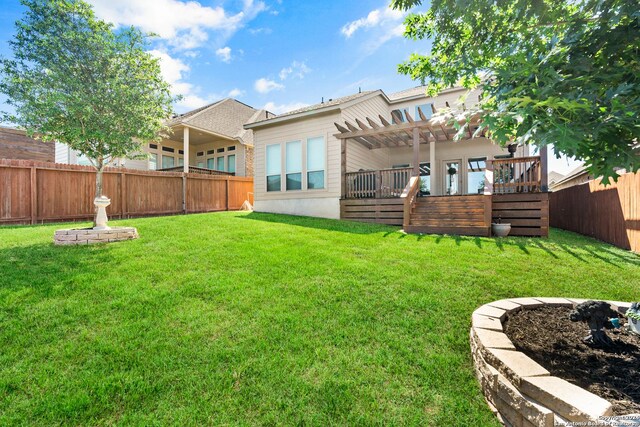 back of property featuring a lawn, a pergola, and a deck