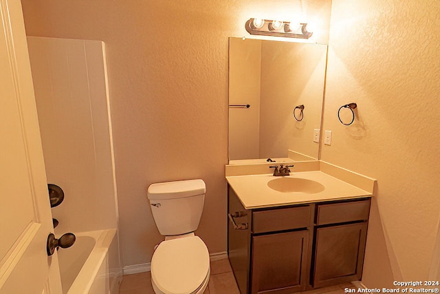 bathroom with toilet, tile patterned floors, and vanity