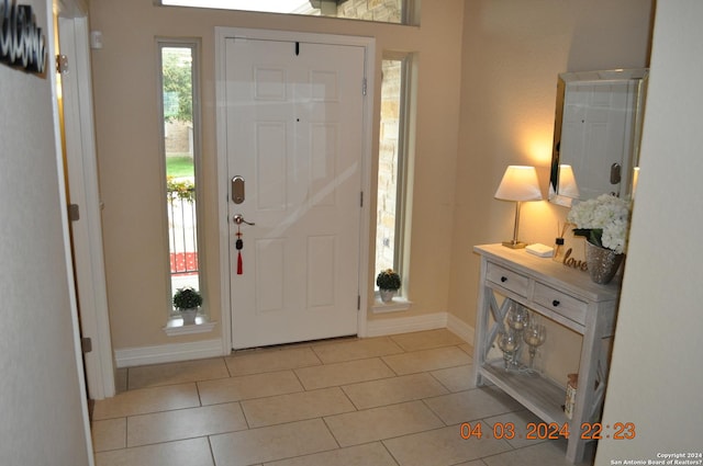 entrance foyer featuring baseboards and light tile patterned floors