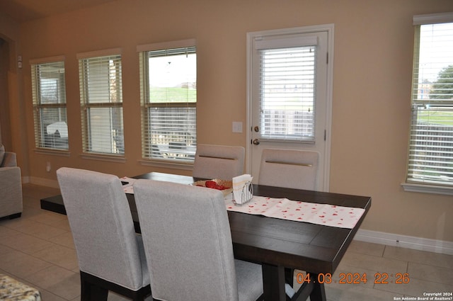 dining room featuring light tile patterned floors and baseboards