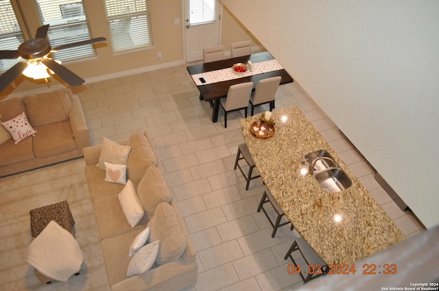 interior space featuring baseboards and light tile patterned flooring