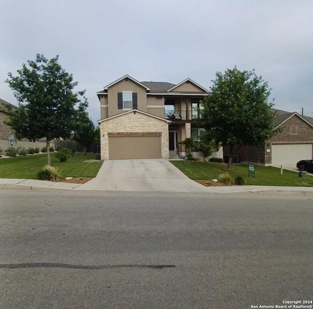 view of front of house with a garage, driveway, stone siding, and a front yard