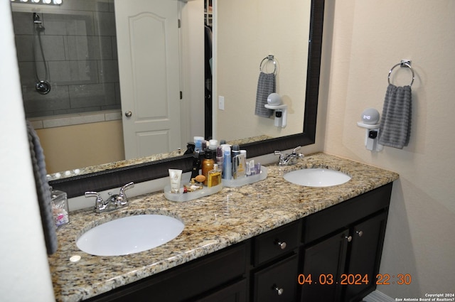 full bathroom featuring double vanity and a sink