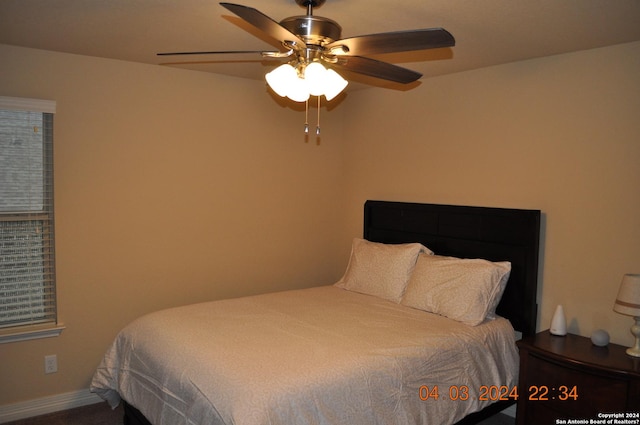 bedroom featuring ceiling fan and baseboards