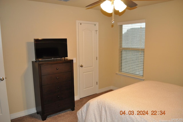 carpeted bedroom with a ceiling fan, visible vents, and baseboards