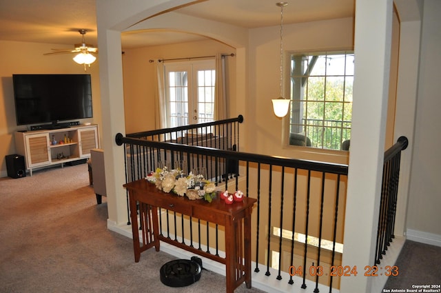 stairs featuring carpet floors, baseboards, arched walkways, and french doors