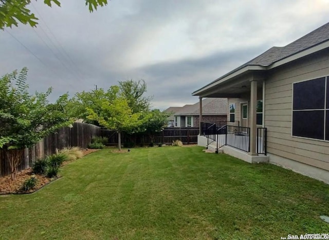 view of yard with a fenced backyard