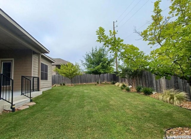 view of yard with a fenced backyard