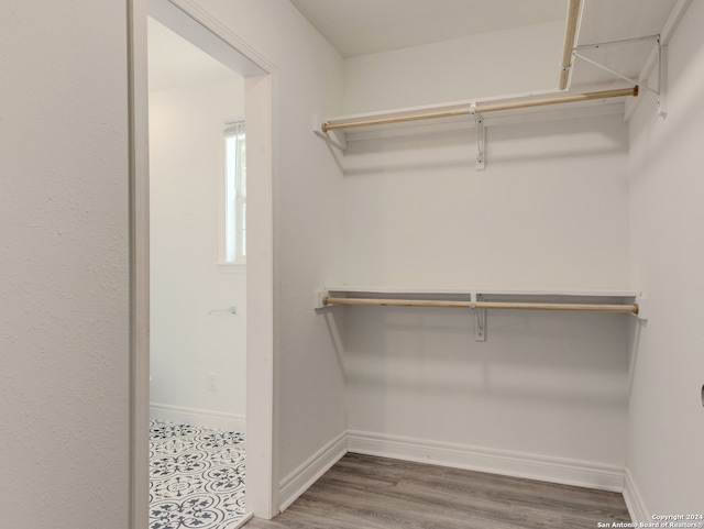 spacious closet featuring dark tile patterned flooring