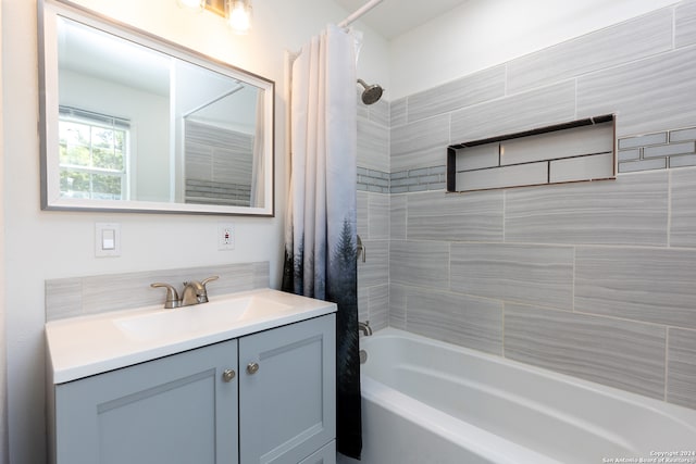 bathroom with shower / bath combination with curtain and vanity