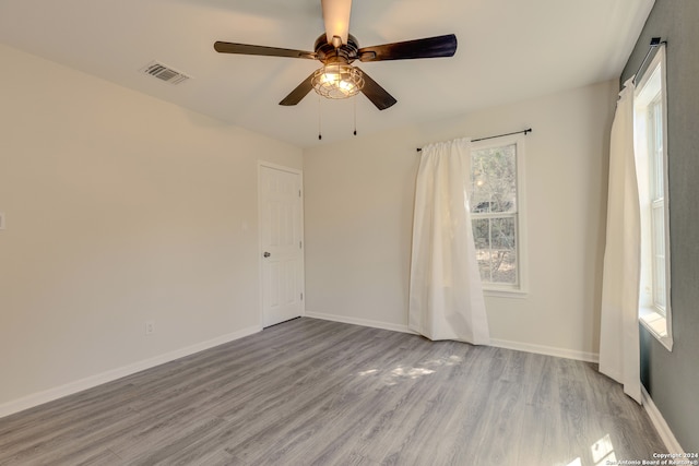 spare room with hardwood / wood-style floors and ceiling fan