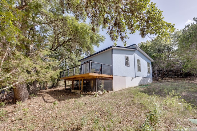 rear view of property featuring a deck