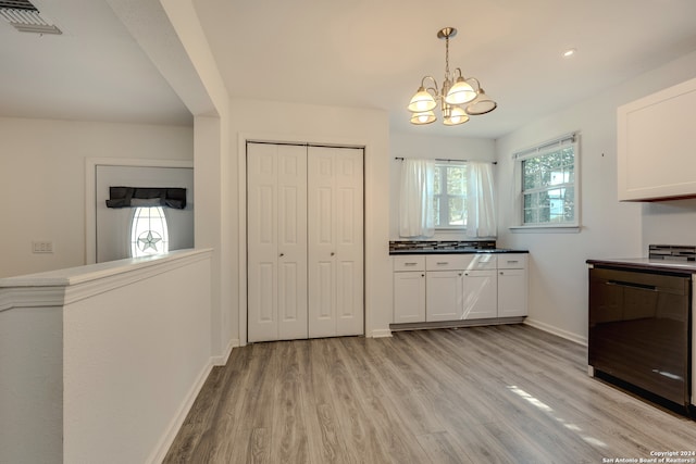 kitchen with dishwasher, light hardwood / wood-style floors, decorative light fixtures, white cabinets, and a notable chandelier