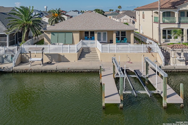 dock area with a balcony and a water view