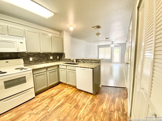 kitchen with sink, light hardwood / wood-style flooring, white appliances, and ceiling fan