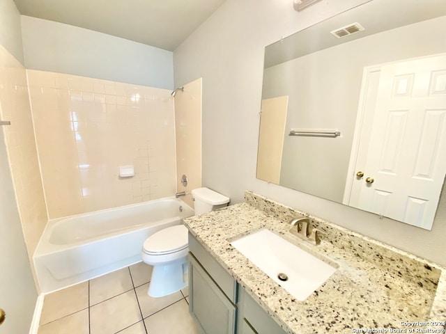 full bathroom featuring toilet, tiled shower / bath combo, vanity, and tile patterned floors