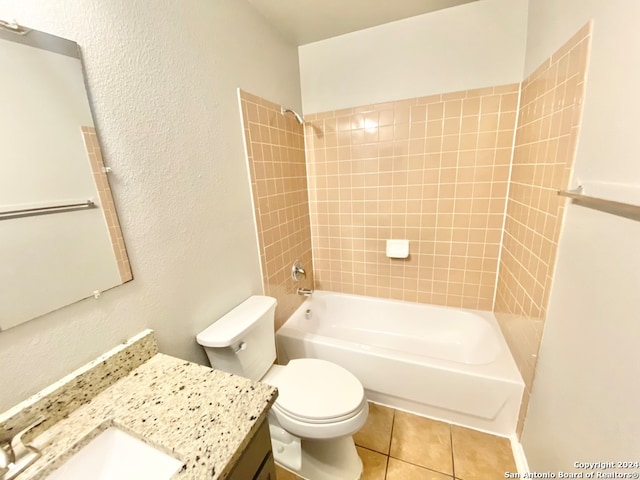 full bathroom featuring tile patterned floors, tiled shower / bath, vanity, and toilet