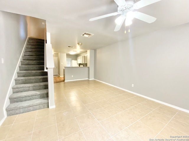 tiled spare room with ceiling fan