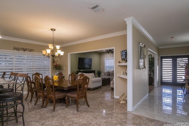 dining room featuring an inviting chandelier, baseboards, visible vents, and ornamental molding