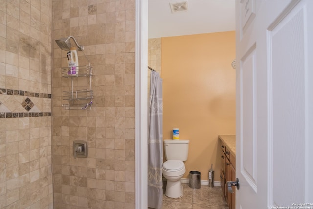 bathroom with toilet, walk in shower, tile patterned floors, and vanity