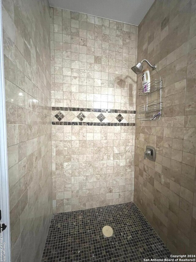 bedroom with ceiling fan, a closet, and light tile patterned floors