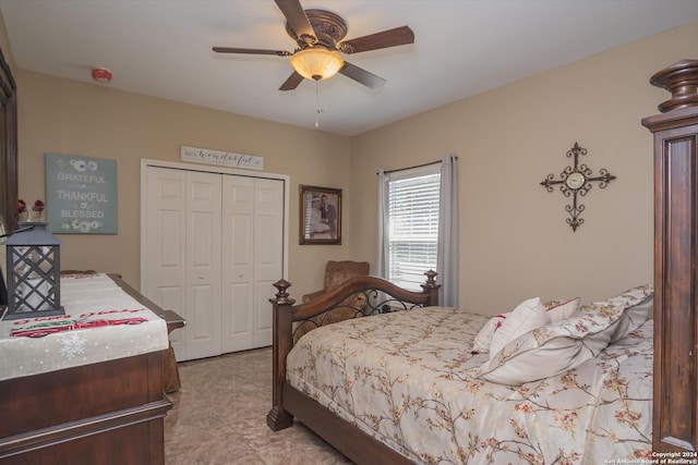 bedroom featuring light tile patterned floors, ceiling fan, and a closet