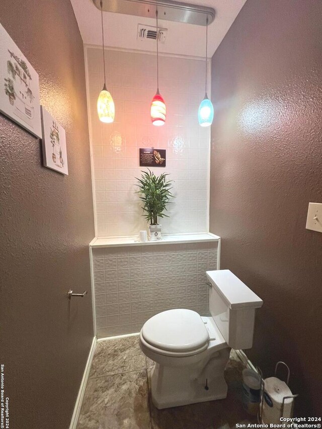 kitchen featuring independent washer and dryer, electric panel, and light tile patterned floors