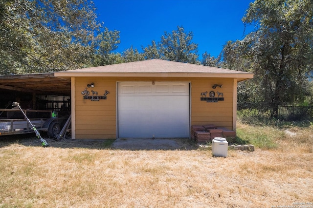 detached garage featuring driveway