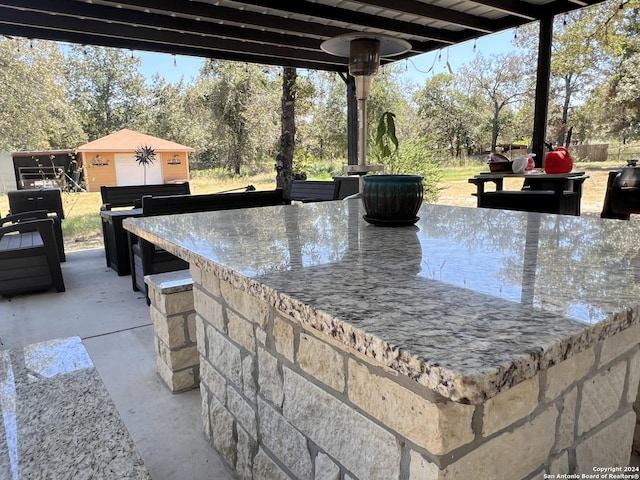 view of patio / terrace with outdoor dry bar and an outdoor structure