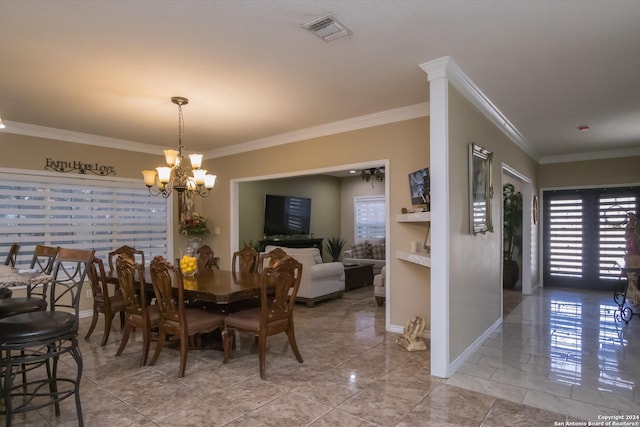 dining space with tile patterned floors, a notable chandelier, and crown molding