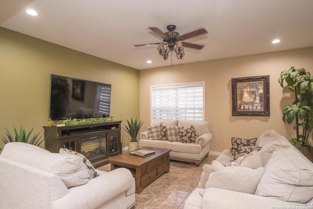 living area featuring a ceiling fan, recessed lighting, a glass covered fireplace, and baseboards