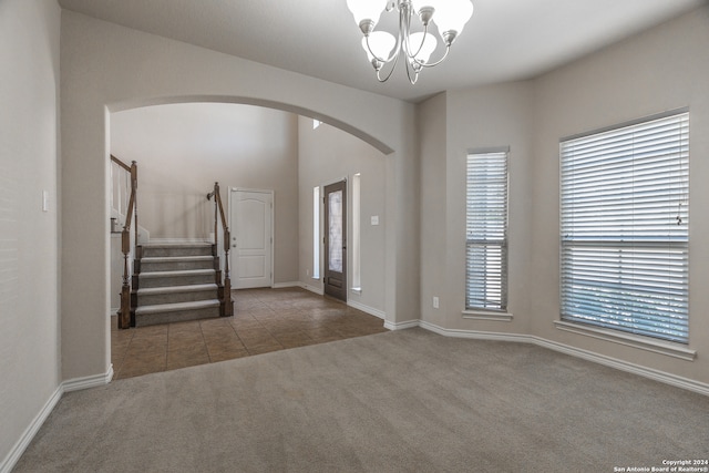 entryway with a chandelier and carpet floors