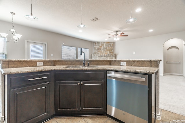 kitchen featuring sink, dishwasher, ceiling fan with notable chandelier, a textured ceiling, and decorative light fixtures