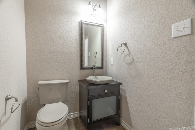 bathroom featuring toilet and vanity