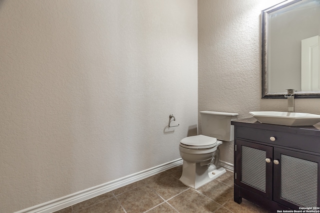 bathroom featuring vanity, toilet, and tile patterned floors