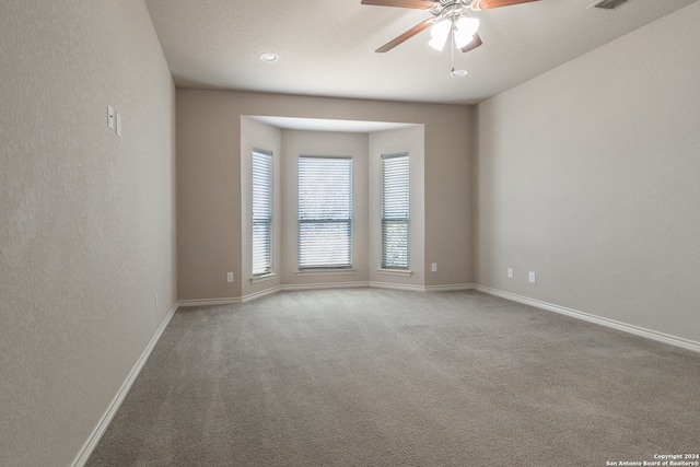 spare room with carpet flooring and ceiling fan