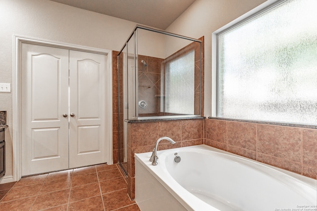 bathroom featuring tile patterned flooring, separate shower and tub, and vanity