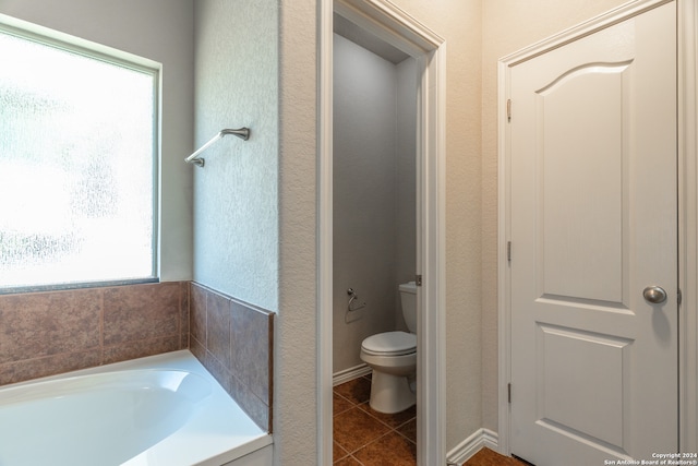 bathroom featuring a bathtub, toilet, and tile patterned floors