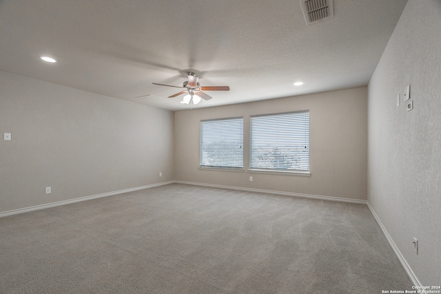 carpeted spare room with ceiling fan