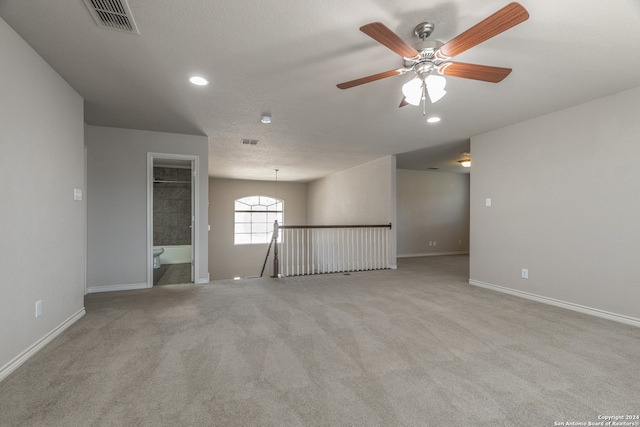 unfurnished room featuring ceiling fan and light colored carpet