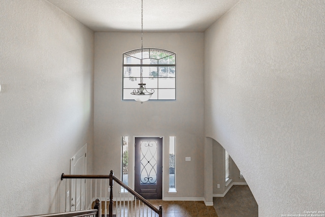 foyer featuring a textured ceiling and tile patterned flooring